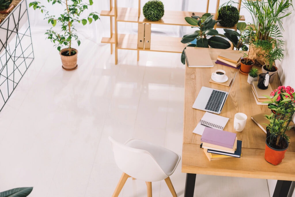 Home office with laptop on desk for the article How To Start a Business With No Money